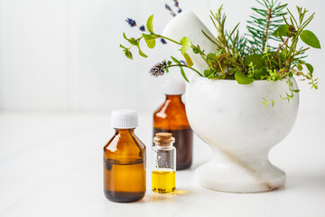 Bottles of essential oil, white background. Healthy cosmetics concept.