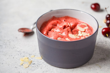Healthy vegan breakfast bowl. Berries cherry smoothie in gray bowl.
