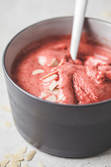 Healthy vegan breakfast bowl. Berries cherry smoothie in gray bowl.