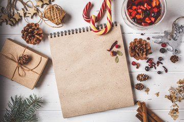 Christmas composition background. Christmas tree, cones, toys and gift packing on white wooden background.