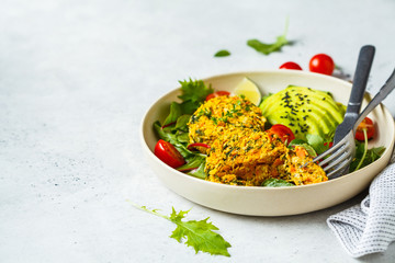 Vegan pumpkin and quinoa cutlets with salad in a white plate.