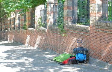 Homeless man sleeps on street in downtown Madrid Spain.