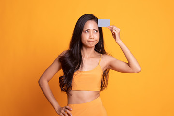 Young Asian woman think with a blank card.