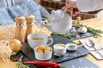 beautiful boulevard server in a restaurant on a table with the hand of a waiter who serves it