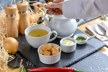 beautiful boulevard server in a restaurant on a table with the hand of a waiter who serves it