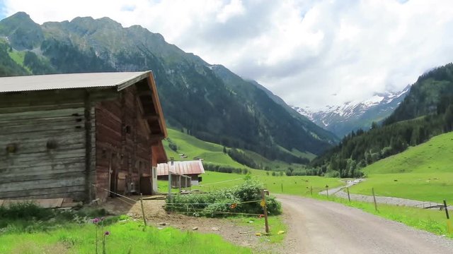 Old wooden barn on Schoenachtal valley in Tirol Austria. Hiking trail through the valley.