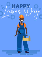 Happy labor day poster design with an african-american workman carrying a toolbox, wearing a hardhat below text and industrial gears in a colorful blue themed vector illustration