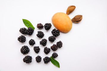 blackberry and apricot in the form of beetle isolated on white background