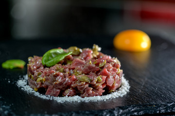 calf tartare on black slate