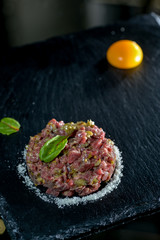 calf tartare on black slate