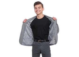 Fototapeta premium Handsome caucasian Teen Boy in gray suit and black T-shirt, isolated on white background. Teenager looking at camera. Happy child - portrait.