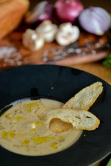 mushroom cream soup in a black round plate