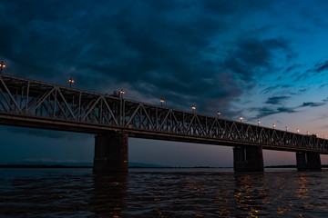 Bridge over the Amur river at sunset. Russia. Khabarovsk. Photo from the middle of the river.