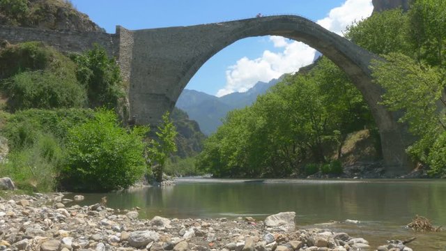 Medieval stone bridge. Konitsa bridge and Aoos River, Greece.