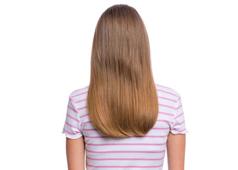 Rear view of teen girl with long hair, isolated on white background. Portrait of caucasian child - back view.