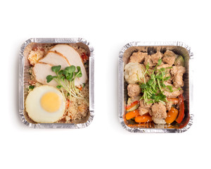 Lunch fot two in foil boxes to go with healthy food on white