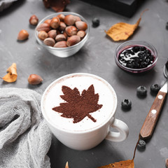 Close-up of coffee mug, jam and chestnuts