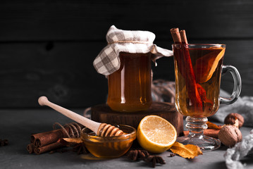 Tea with honey and black background