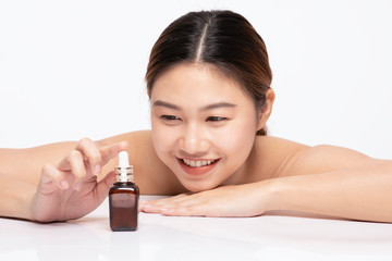 Obraz na płótnie Canvas Beautiful Asian young woman smile and touching serum for Moisturize skin smile with healthy Clean and Fresh skin feeling so happiness and cheerful,Isolated on white background,Beauty Concept