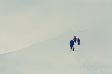 Fototapeta na wymiar Group of hikers in the mountain. Climb to the top