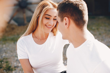 Cute couple in a park. Lady in a white t-shirt.