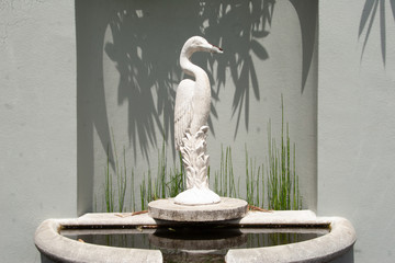 Crane fountain with leaf shadows - obrazy, fototapety, plakaty