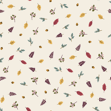 Seamless pattern of autumn leaves, twigs, berries and acorns.