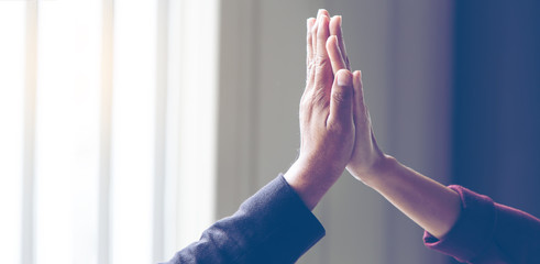 Fototapeta premium Businessmen, men and two women put together shaking hands to show the victory in the work they performed to show the victory in the work they performed, for panoramic banner background with copy space