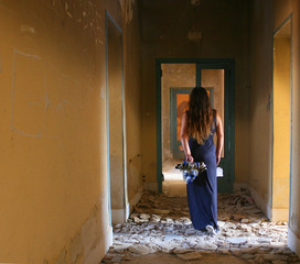 WOMAN FROM BEHIND WITH MASK IN THE OLD ABANDONED BUILDING