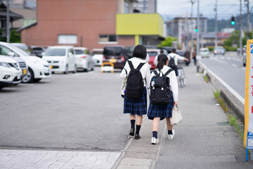 Japanese students are walking home with friends.