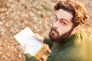 Forester with checklist on clipboard