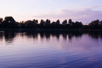 purple sunset on the river with reeds