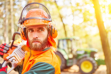 Forest worker with chainsaw and safety