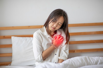 Woman have a heart attack in chest pain after wake up in the morning,Healthcare Concept