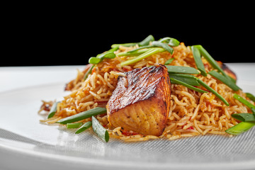 Pilaf with salmon on a white plate