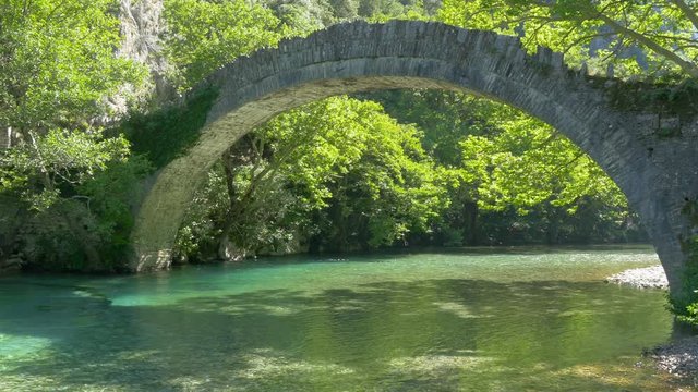 Medieval stone bridge. Konitsa bridge and Aoos River, Greece.