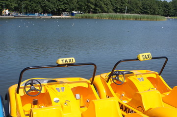 water taxi yellow, pedalo on a lake