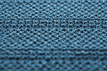 Wool knitted blue background with texture.Shallow depth of field.