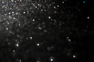 Shiny black background with blur. Bokeh