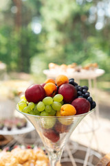 Fruits in glass. Wedding decor. Summer wedding in the wood. grapes, apricots, peaches - 282257650