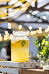Glass jars of lemonade on wedding candy bar. Catering. Drinks on wedding party. Summer wedding in the forest - 282258012