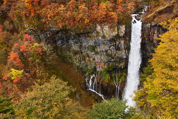 View of vibrant autumn colors (foliage) at Kegon falls from the lower observatory, Nikko,  Kanto...