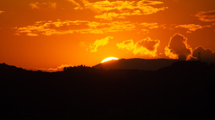 Colorful orange sunset over mountains