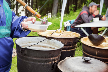 Cooking outdoors. Charity. To feed the hungry homeless people.