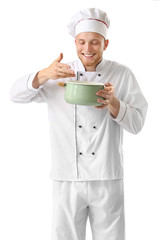 Handsome male chef with soup on white background