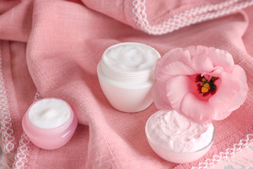 Body cream in jars on table