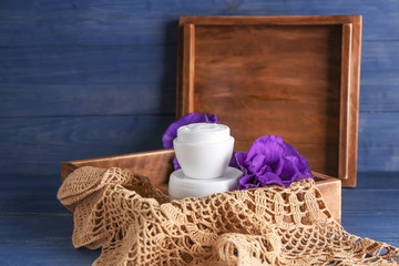 Box with body cream on table