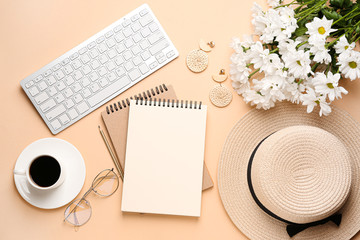 Computer keyboard with notebooks, cup of coffee and female accessories on color background