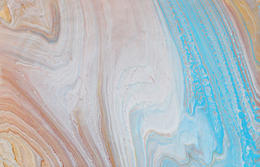 photography of abstract marbleized effect background. Blue, gold and white creative colors. Beautiful paint