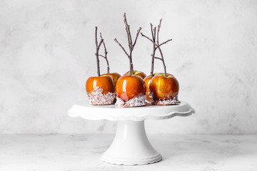 Dessert stand with tasty candy apples on table